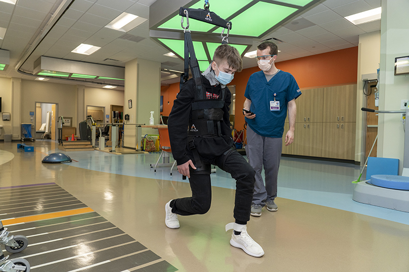 CHKD patient with physical therapist in the physical therapy gym at CHKD