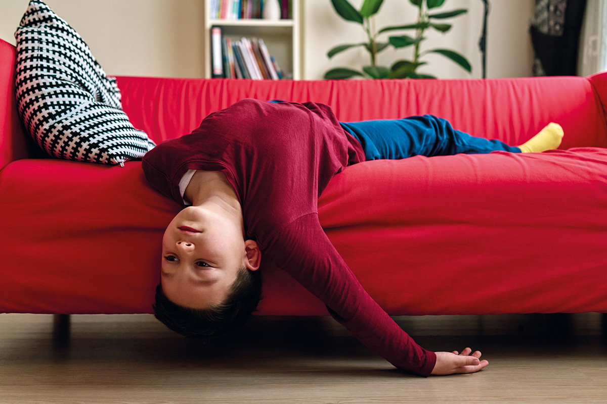 Bored child on living room couch.