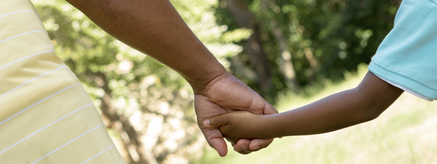 Father and son holding hands.