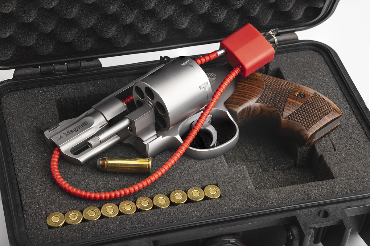 Hand gun with cable key locked on case background