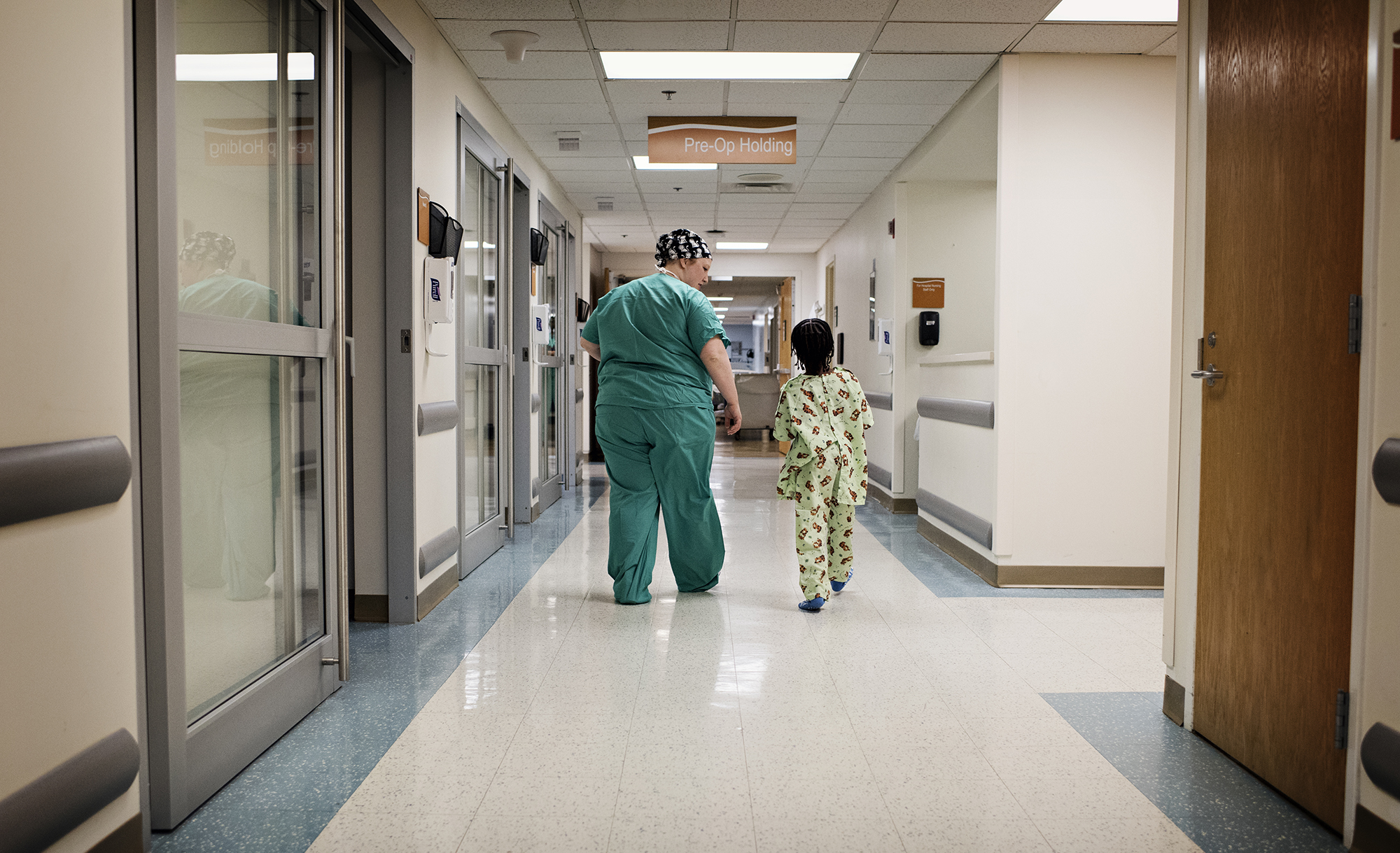 CHKD OR Nurse walks young patient to surgery.