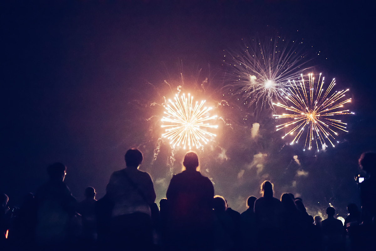 Crowd watching fireworks and celebrating.