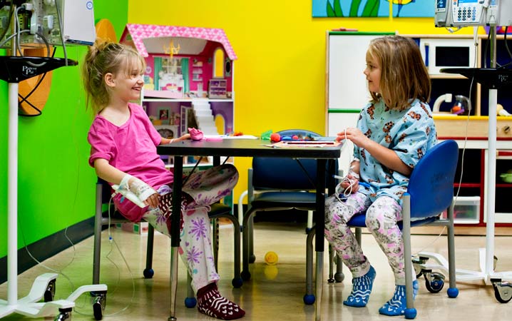 New found friends Kylie And Rowyn play together in the playroom at CHKD.