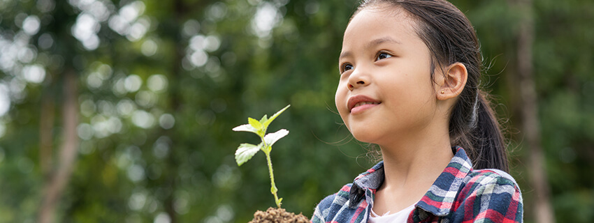 Asian girl holding a plant sprout