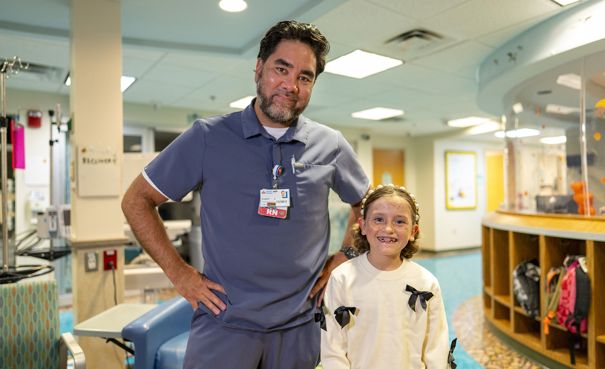 CCBDC nurse Rob Ericson and a young female patient in the cancer and blood disorders center at CHKD.