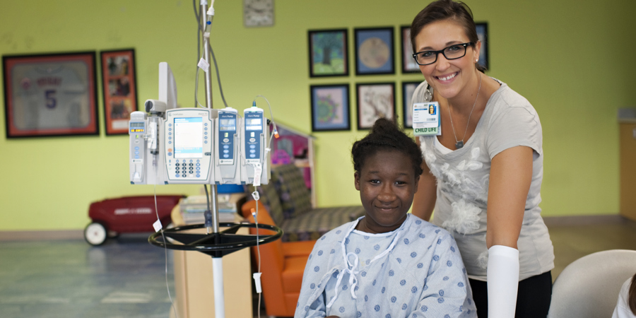 Child Life Specialist Tricia Taylor with a patient in the 8th floor playroom.