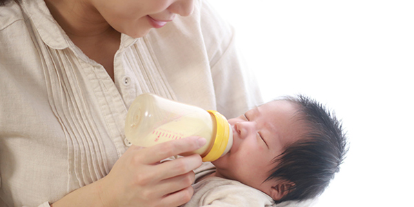Mother bottle feeding her baby.