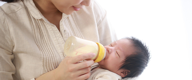 Mother bottle feeding her baby.