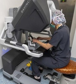 Surgeon at CHKD working the robotic system