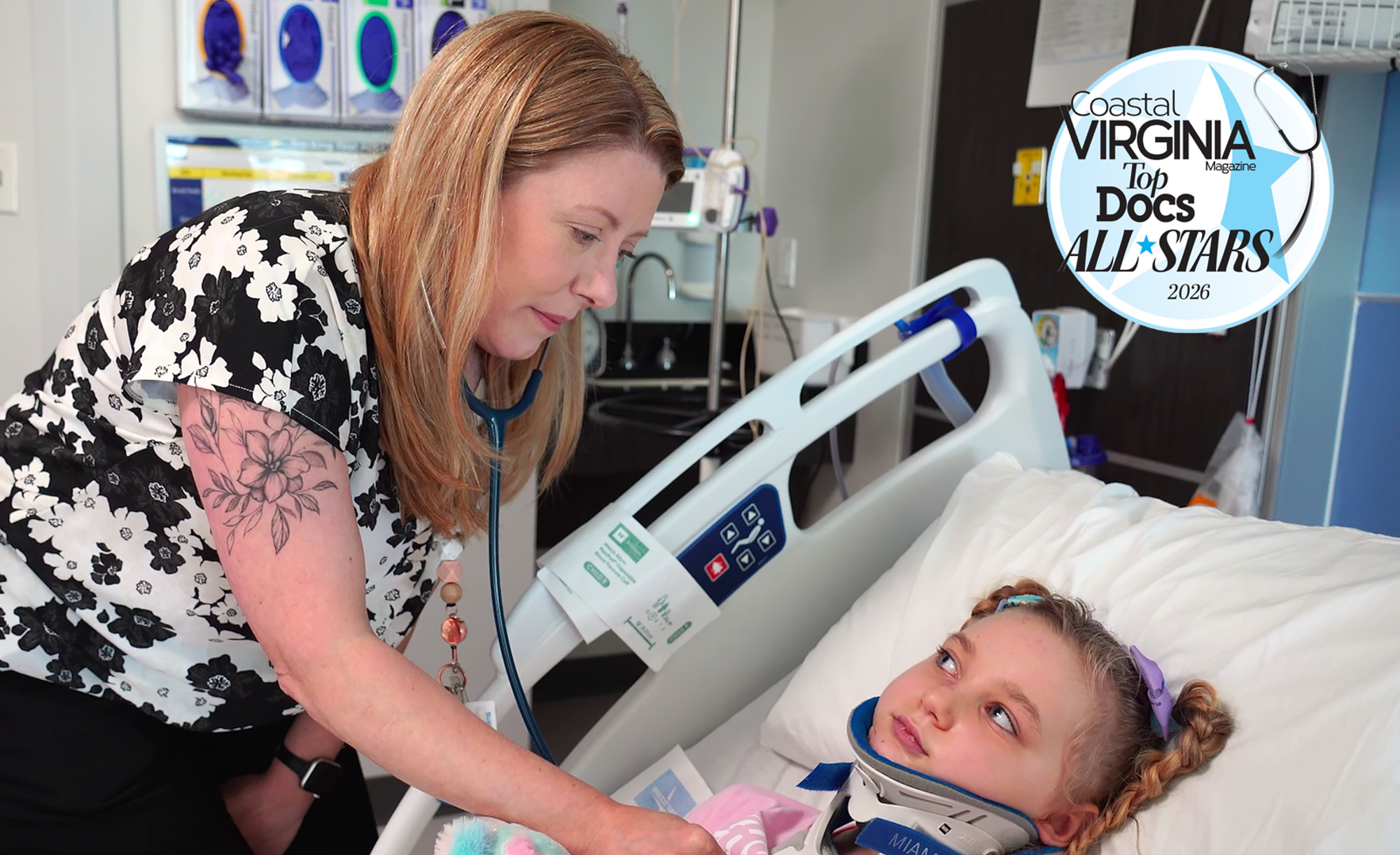 CHKD pediatric cardiologist Dr. Michael Vance smiling with a patient in an exam room.