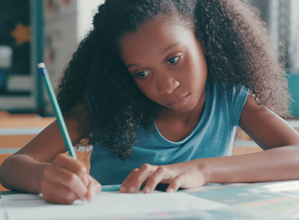 Shot of a young girl focusing on doing schoolwork