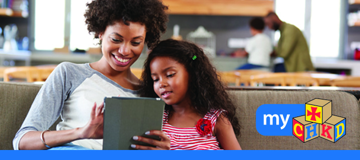 Patient and parent using tablet to access myCHKD.