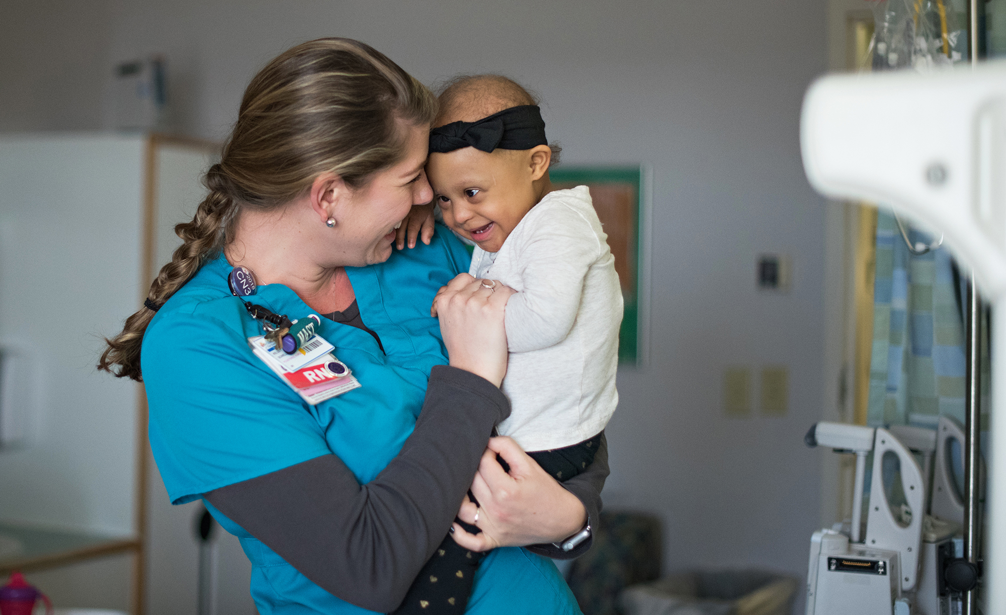 CHKD Nurse Holding And Smiling With Toddler Patient