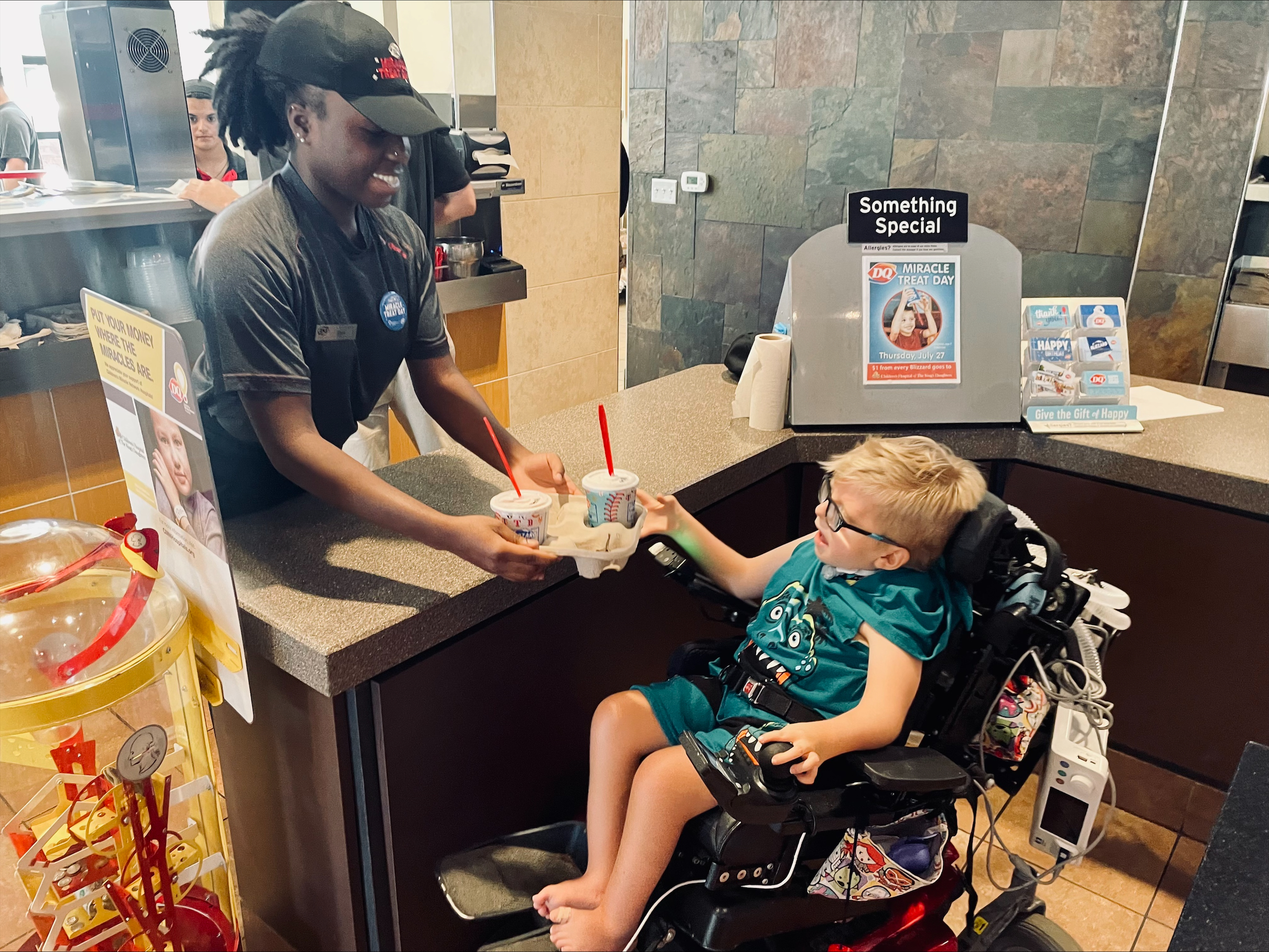 Child in wheelchair reaching for his Blizzard at Dairy Queen.