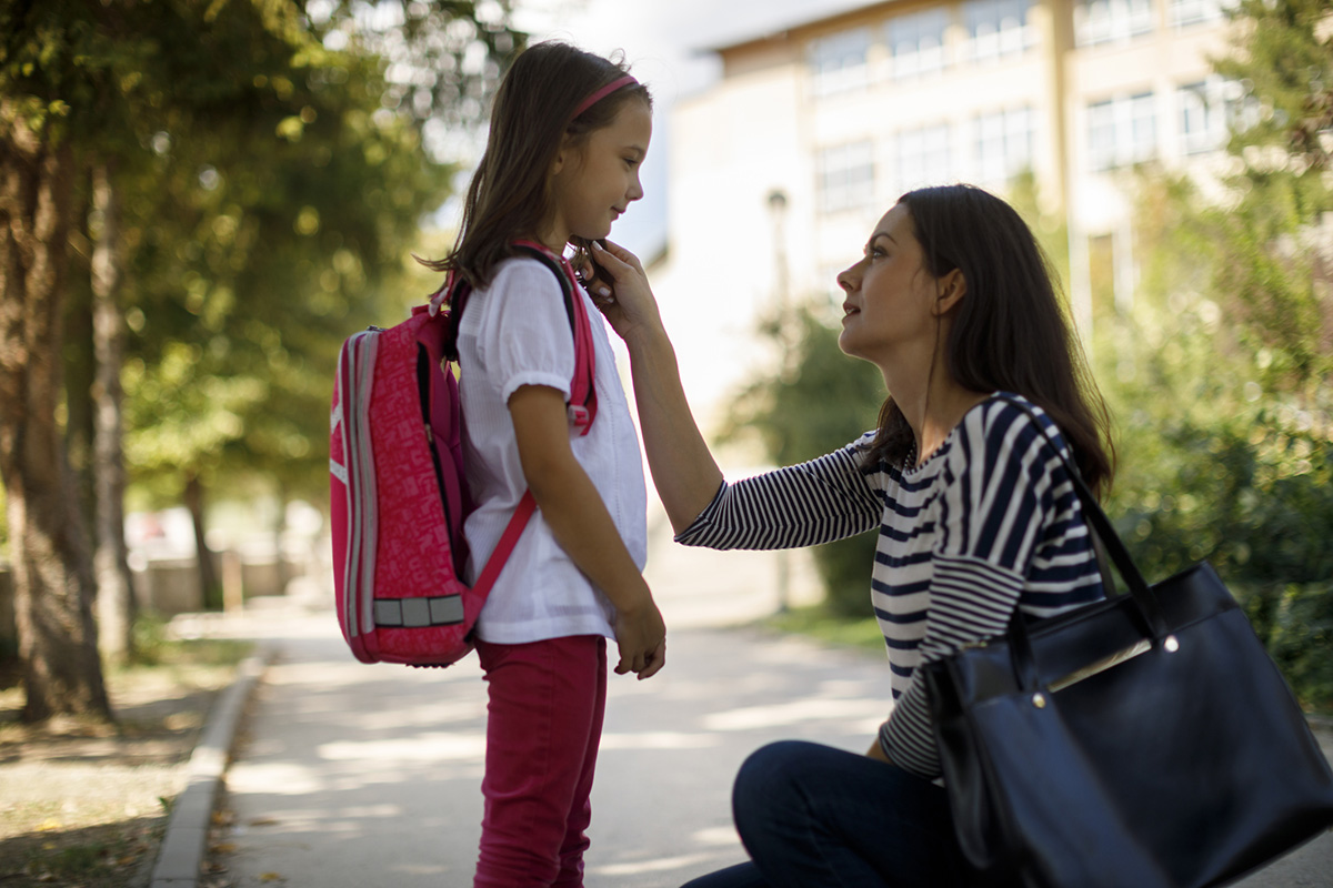Mother taking daughter to school