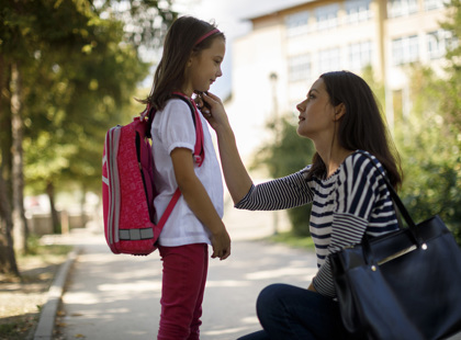 Mother taking daughter to school