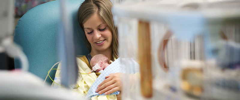 Mom holding a baby in the NICU at CHKD