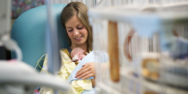 Mom holding a baby in the NICU at CHKD