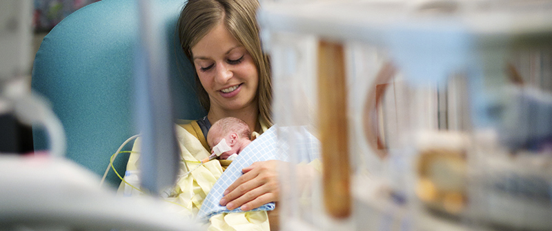 Mom holding a baby in the NICU at CHKD