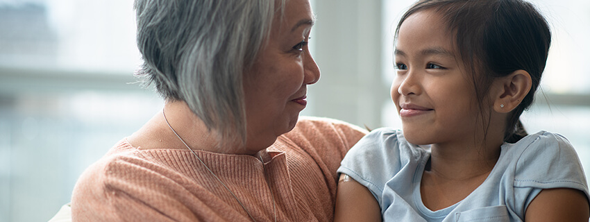 Grandma and girl smiling at each other
