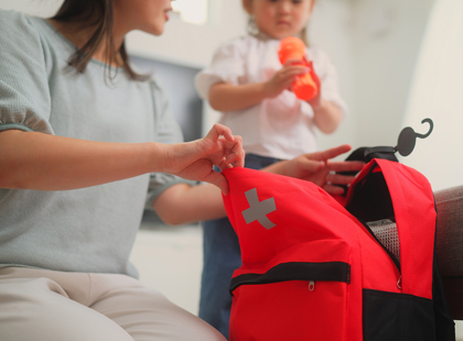 Woman preparing emergency bag at home