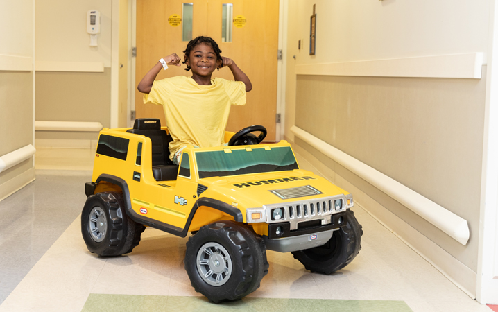 African American patient taking a toy hummer to surgery at CHKD.
