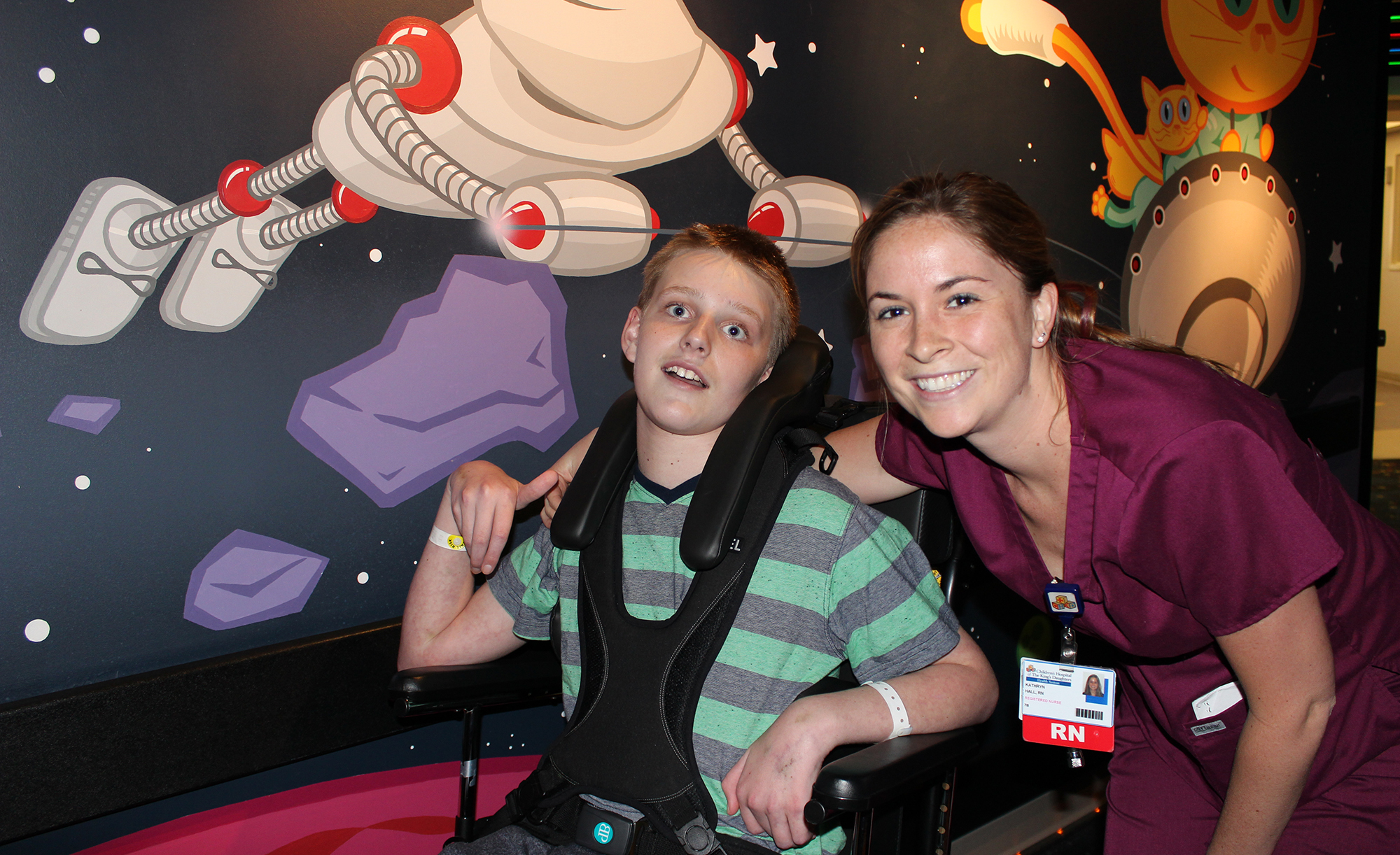 CHKD Nurse Smiles With A Patient In A Wheelchair On The Rehab Unit