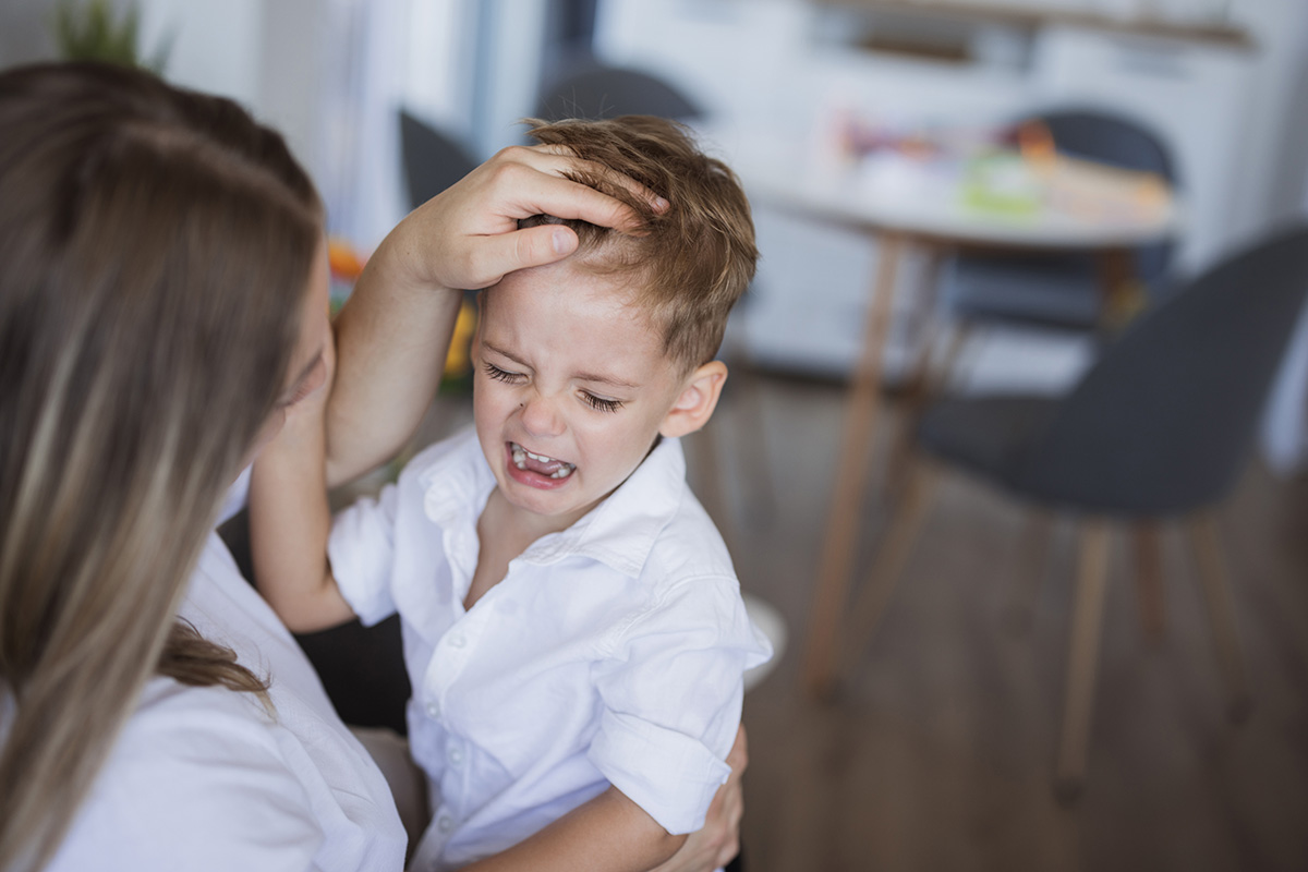 KH Blog Mom Consoling Crying Son Stock
