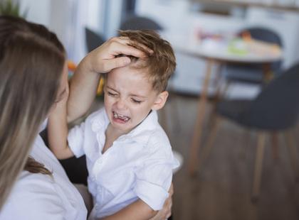 KH Blog Mom Consoling Crying Son Stock