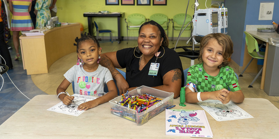 CHKD child life specialist playing in the playroom with a patient.