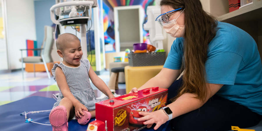 CHKD child life specialist playing in the playroom with a patient.